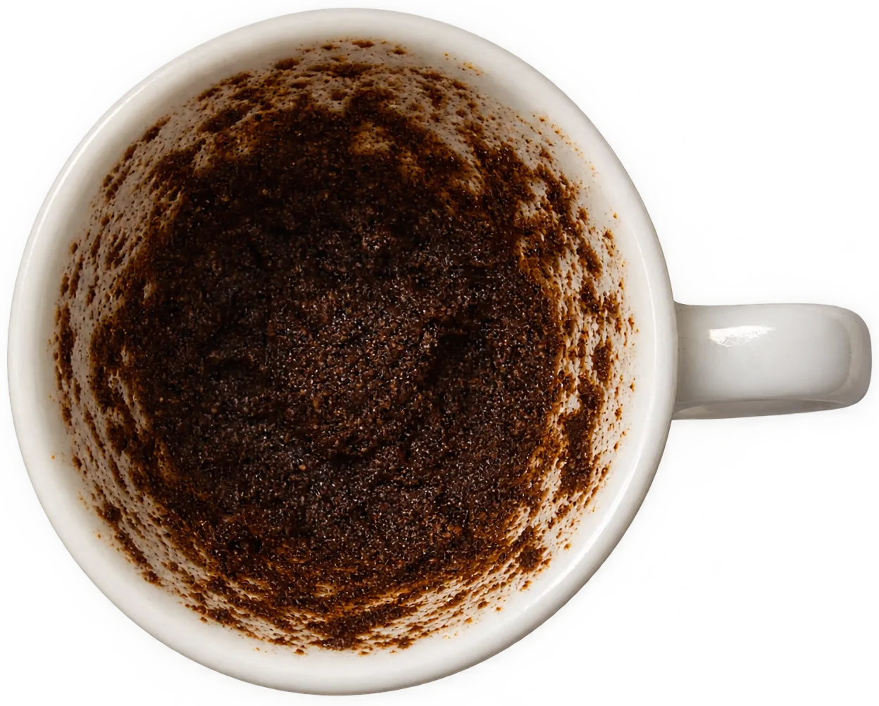 A Turkish coffee cup seen from above, its inside coated with dried grounds.